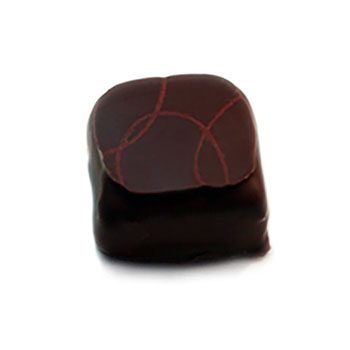Hand dipped praline with a geometric maroon pattern on top