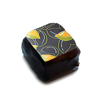Hand dipped praline with a pressed lemon pattern on top