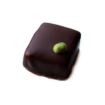 Hand dipped praline with a singular green chocolate ball on top