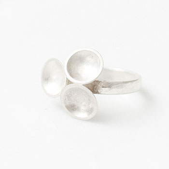 Silver ring with what looks like a flower on top build up of three silver bowls